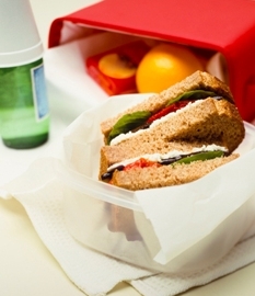Packed lunched box, with veggie sandwich on whole wheat.