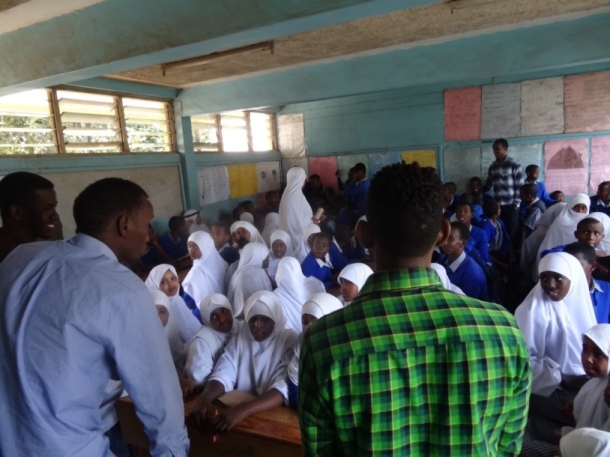 A group of “gang” members (pictured in front) speak at an elementary school in the Eastleigh suburb