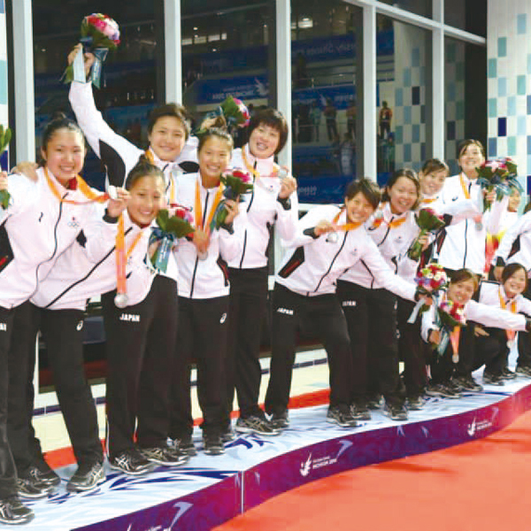 The team is all smiles as they stand on the award podium at the Asian University Water Polo Championship. They took silver despite appearing at the Games for the first time.