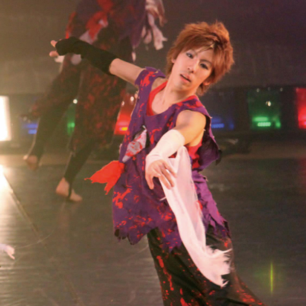 A shot of Kihara participating in a scene with the Oasis student dance club